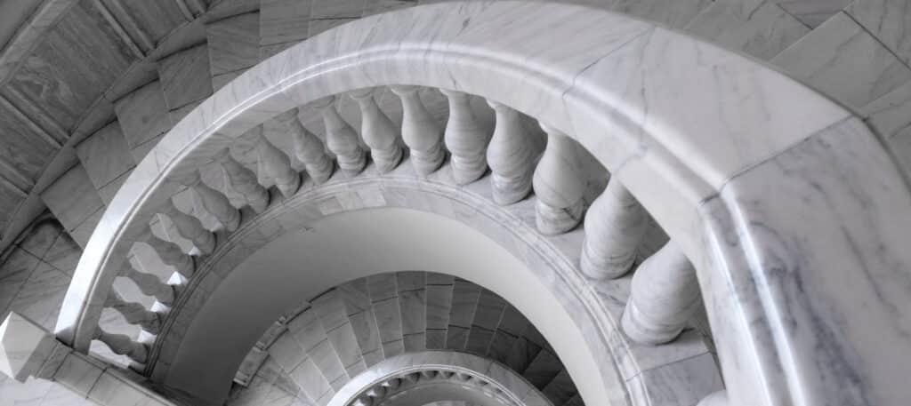 White marble spiral staircase and handrail